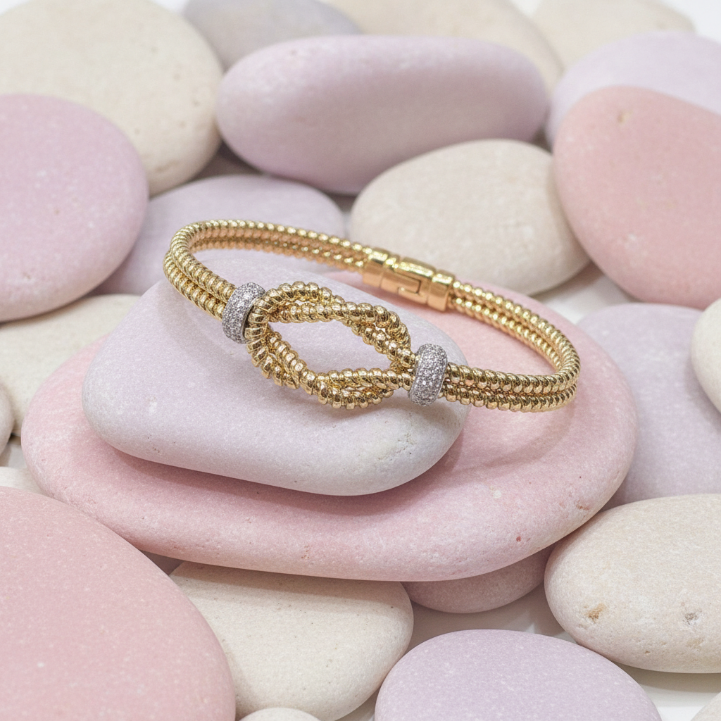 Gold bracelet on pastel rocks