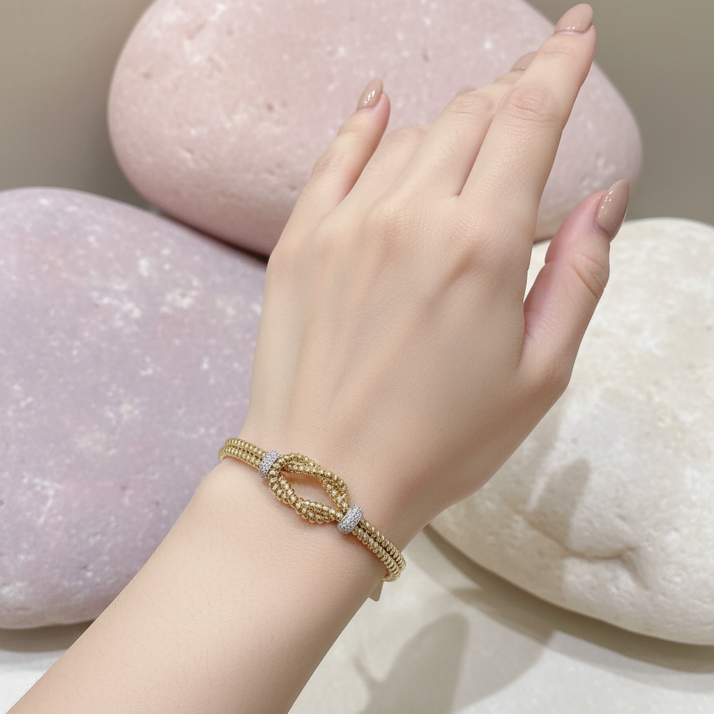 Gold bracelet with model on pastel rocks