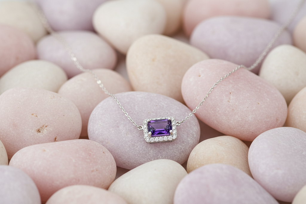 Horizontal amethyst necklace on pastel rocks