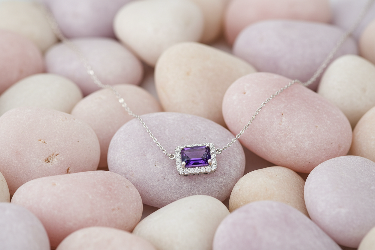 Horizontal amethyst necklace on pastel rocks