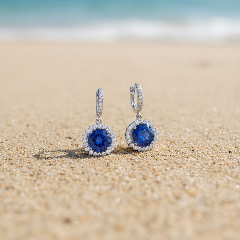 Tanzanite earrings on beach sand - smaller scale